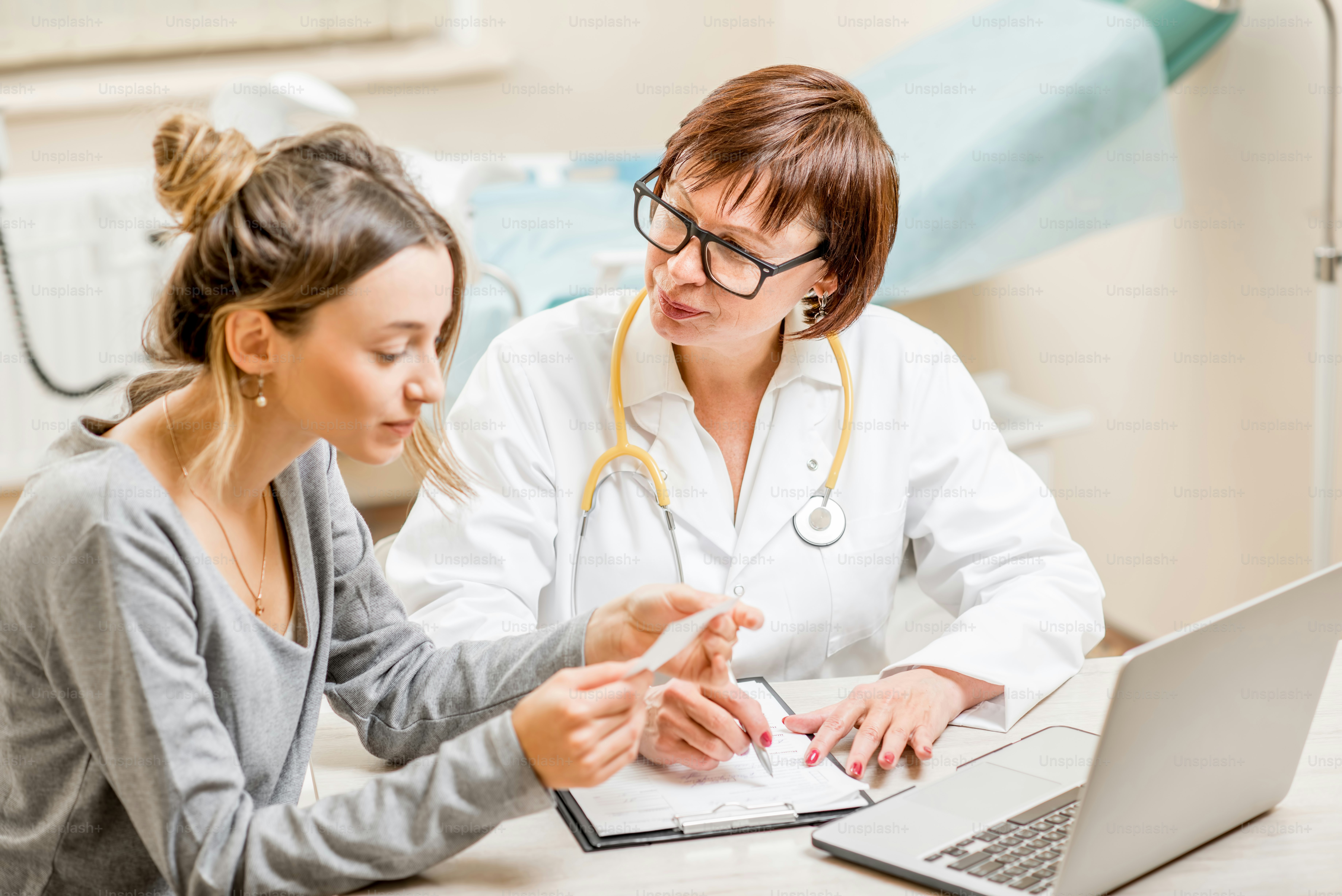 Young woman patient with a senior gynecologist during the consultation in the office