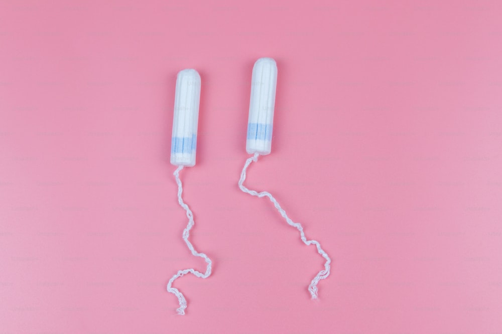 Tampons on a pastel pink background. Top view