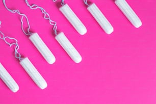 Menstruations-Konzept. Hygieneschutz für Frauen. Baumwolltampons auf rosa Hintergrund