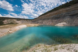 Turqoise lake in an open pit mine