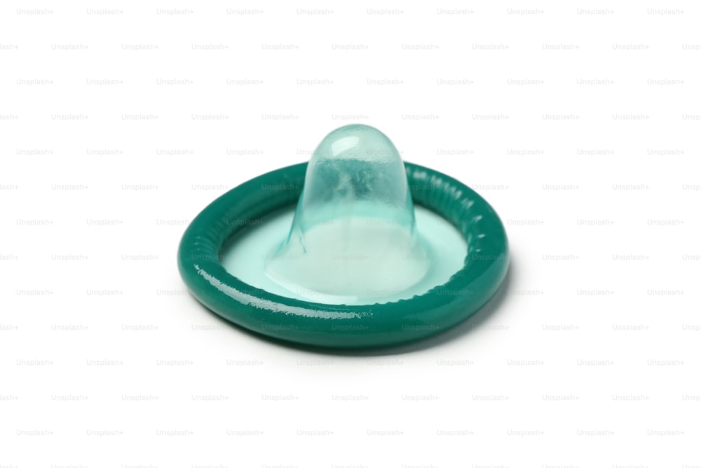 Single mint condom isolated on white background