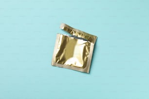 Empty blank condom packaging on blue background