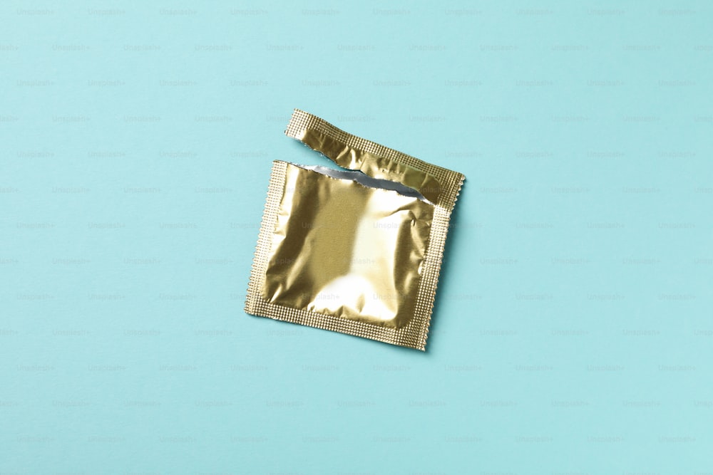 Empty blank condom packaging on blue background