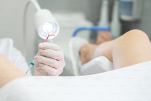 Holding an IUD birth control copper coil device in hand, used for contraception - front view