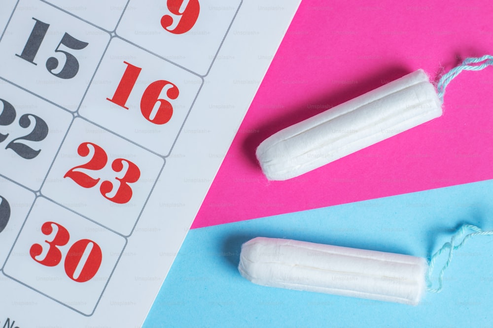 Woman hygiene protection, menstruation calendar and clean cotton tampons