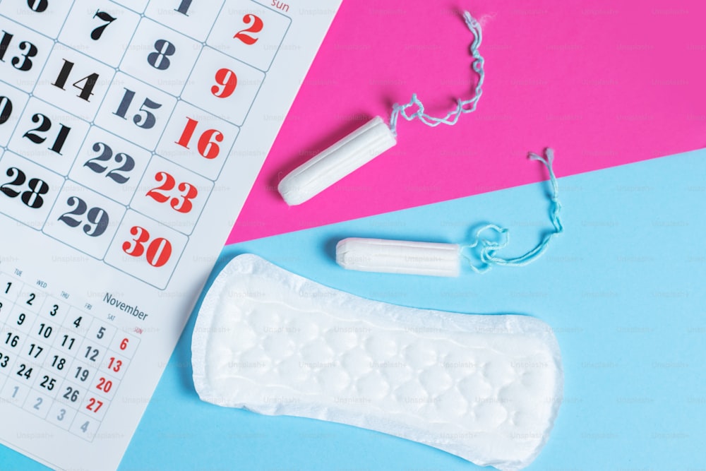 Woman hygiene protection, menstruation calendar and clean cotton tampons and gasket pad