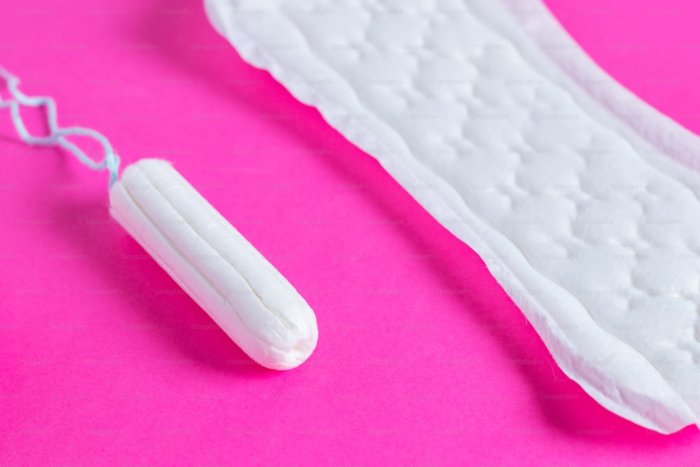Menstrual tampons and pads on a pink background. Menstruation cycle. Hygiene and protection