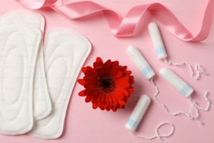 Menstruation period concept on pink background, top view