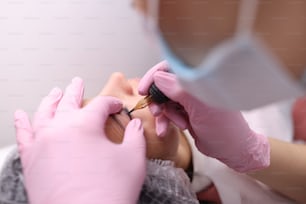 Master performs permanent make-up of eyelids. Types of permanent make-up concept