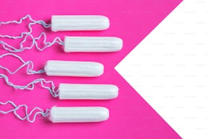 Menstrual period concept. Woman hygiene protection. Cotton tampons on pink background. copy space.