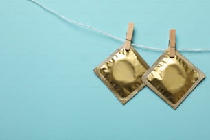 Condoms hanging on the rope on blue background