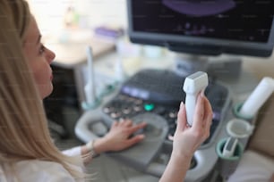 Diagnostician holds equipment for ultrasound examination. Department of ultrasound diagnostics concept