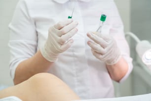 Gynecologist makes an injection. Attractive doctor gynecologist treats the patient