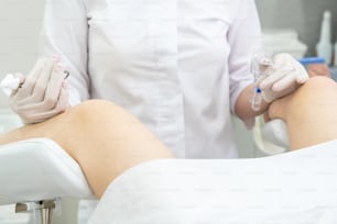 Female gynecologist with vaginal speculum in clinic
