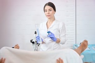 Lady gynecologist is holding in her hands a set for taking biomaterial from the vagina for analysis