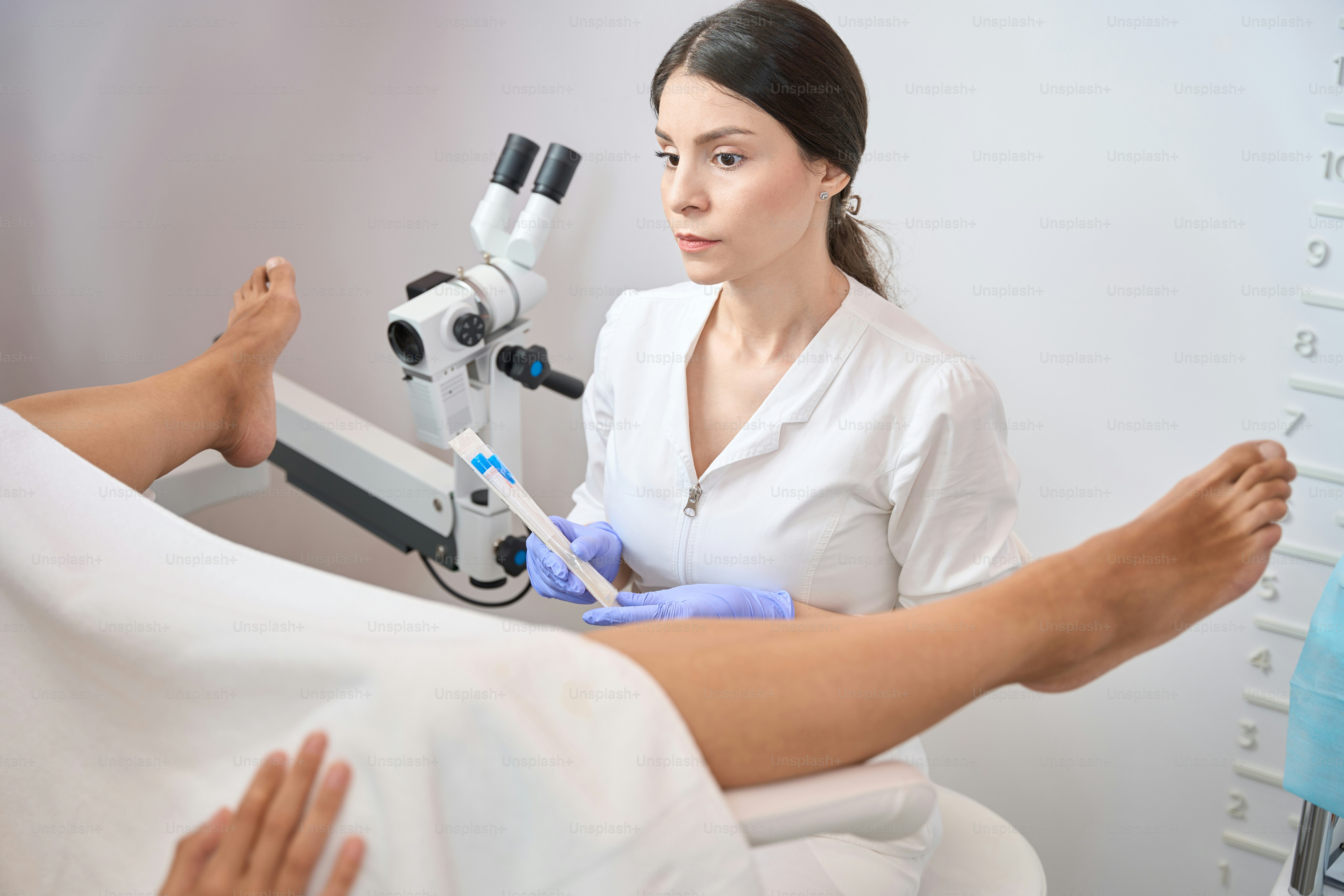 Lady gynecologist holding in her hands a set for taking biomaterial from the vagina for analysis in modern clinic