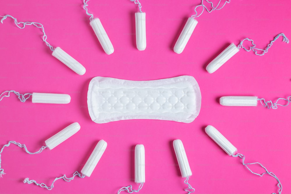 Menstrual tampons and pads on a pink background. Menstruation cycle. Hygiene and protection. copy space.