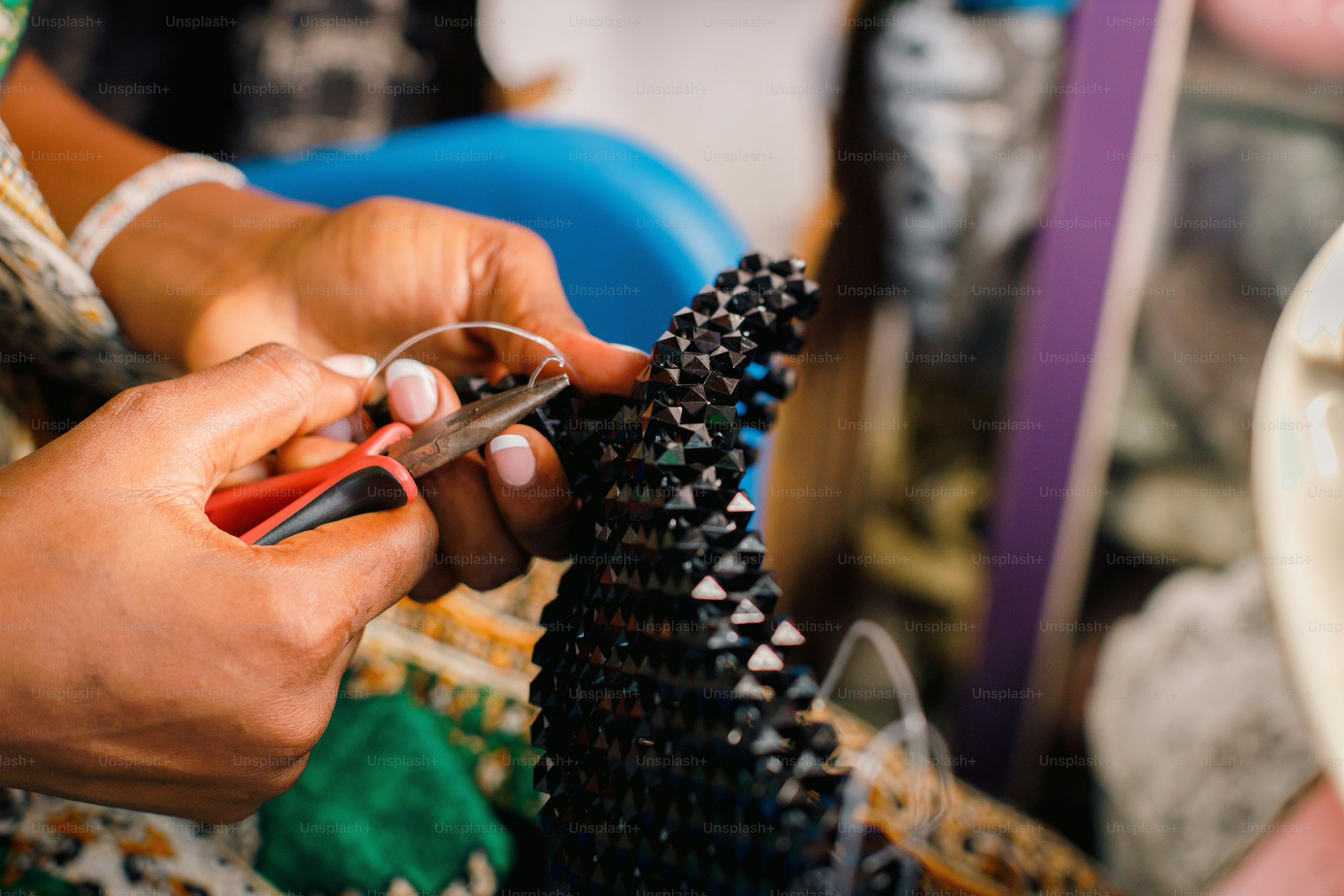 a person cutting a piece of art with a pair of scissors