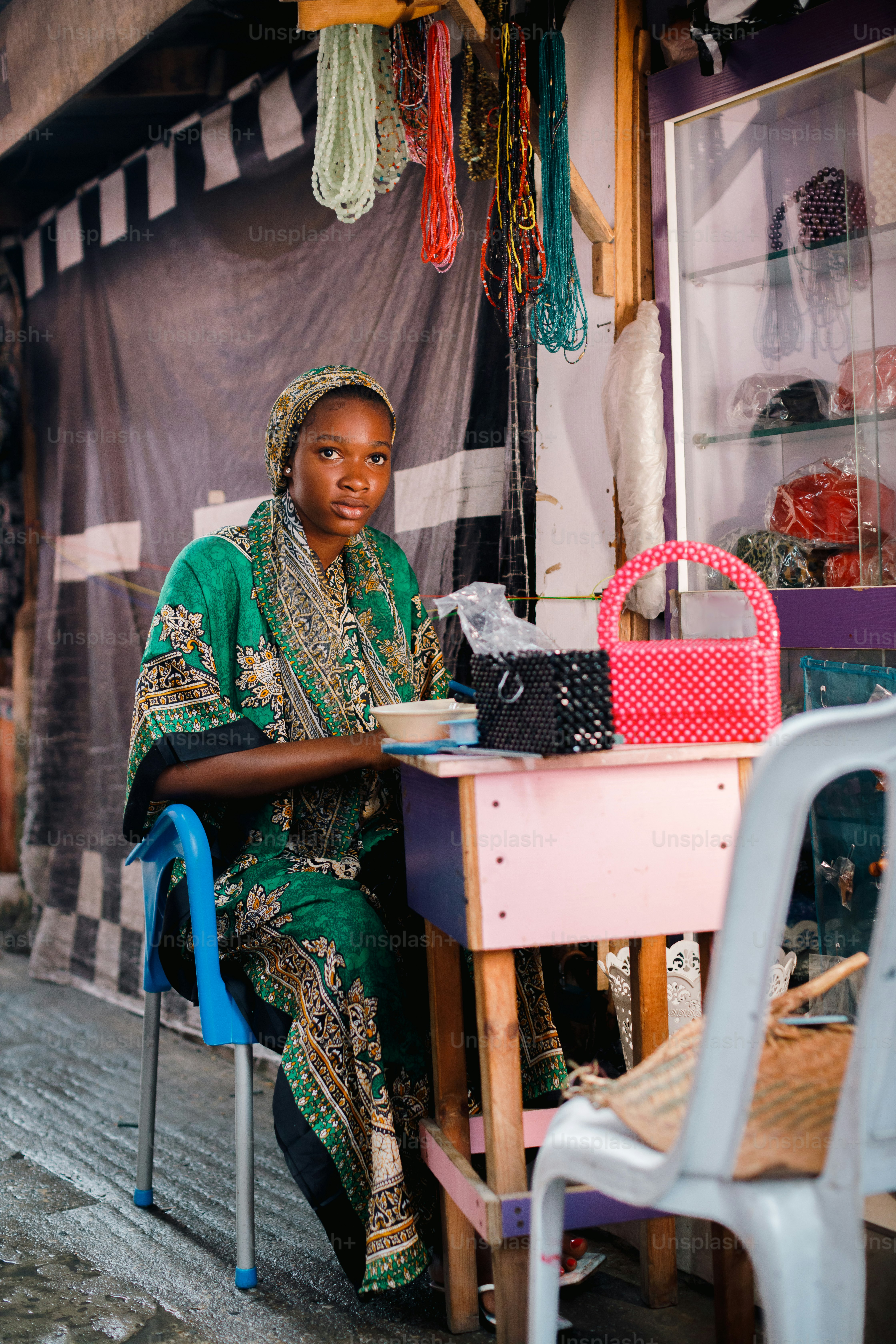 a woman sitting at a table in front of a store