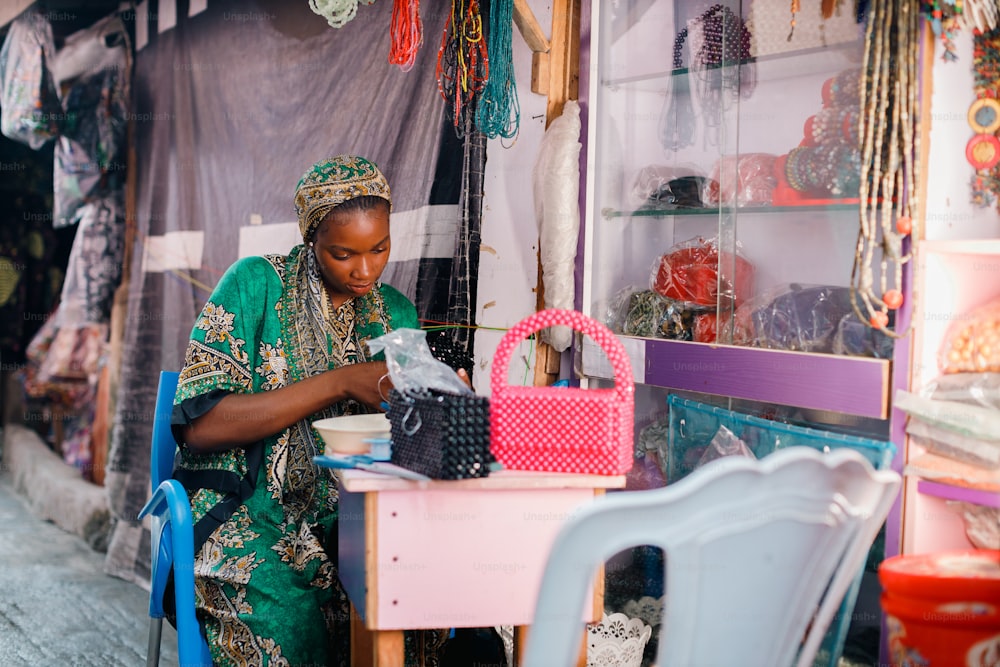 a woman is working on a bag in a shop