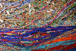 a large pile of colorful beads on a table
