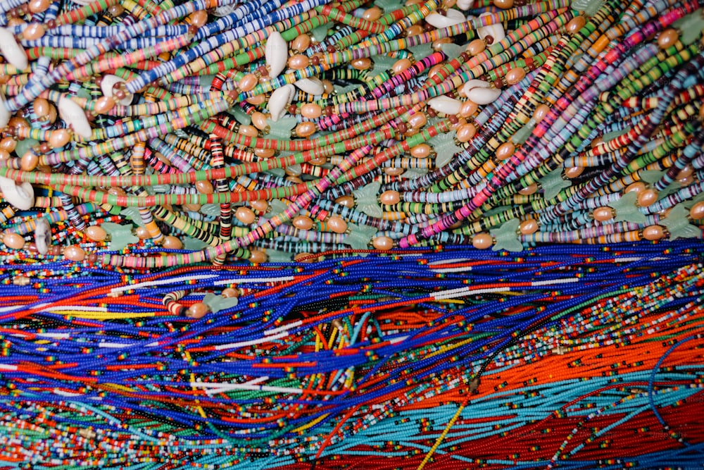 a large pile of colorful beads on a table