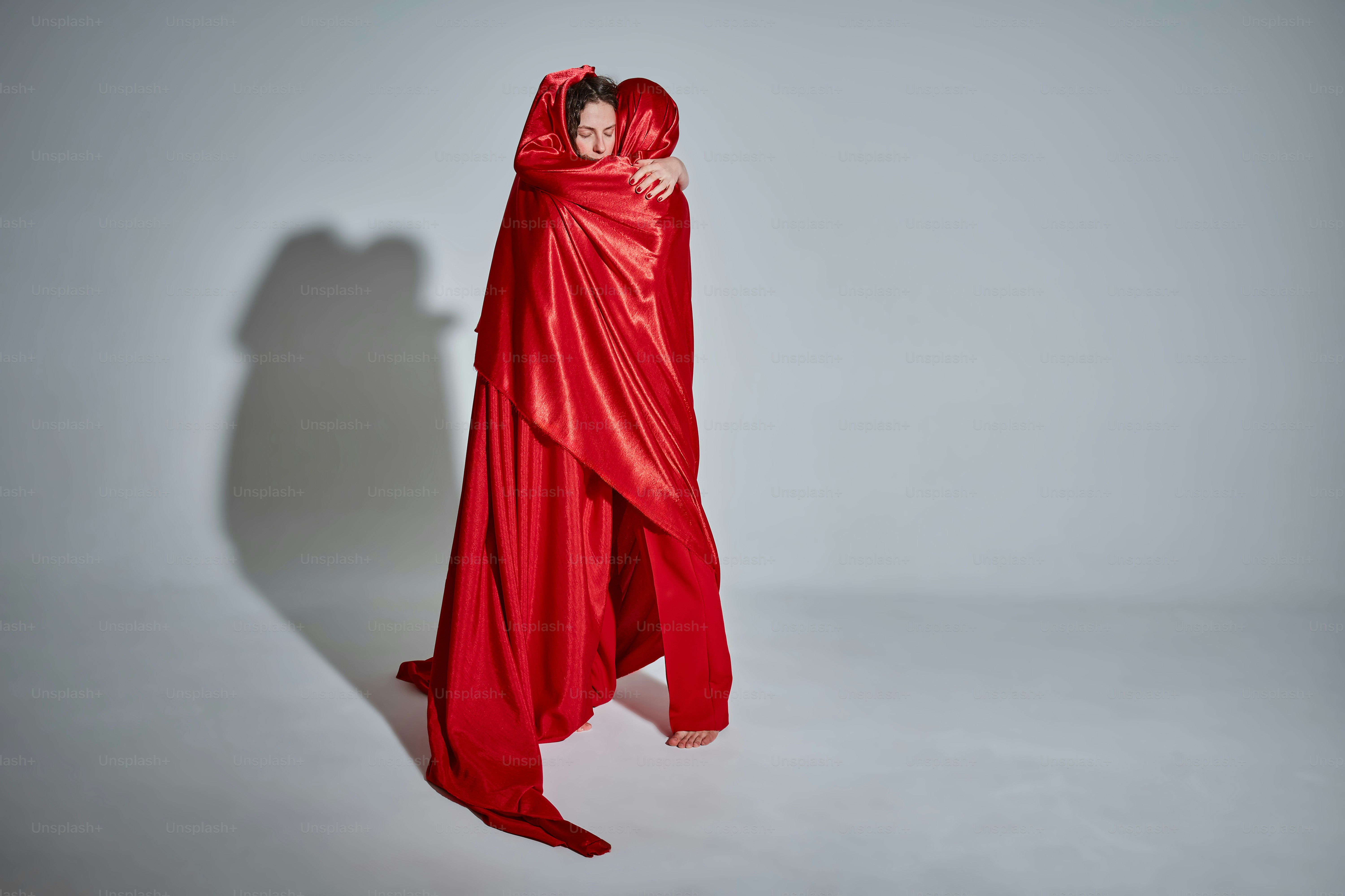 A woman in a red dress is wrapped in a red cloth photo – Valentine ...