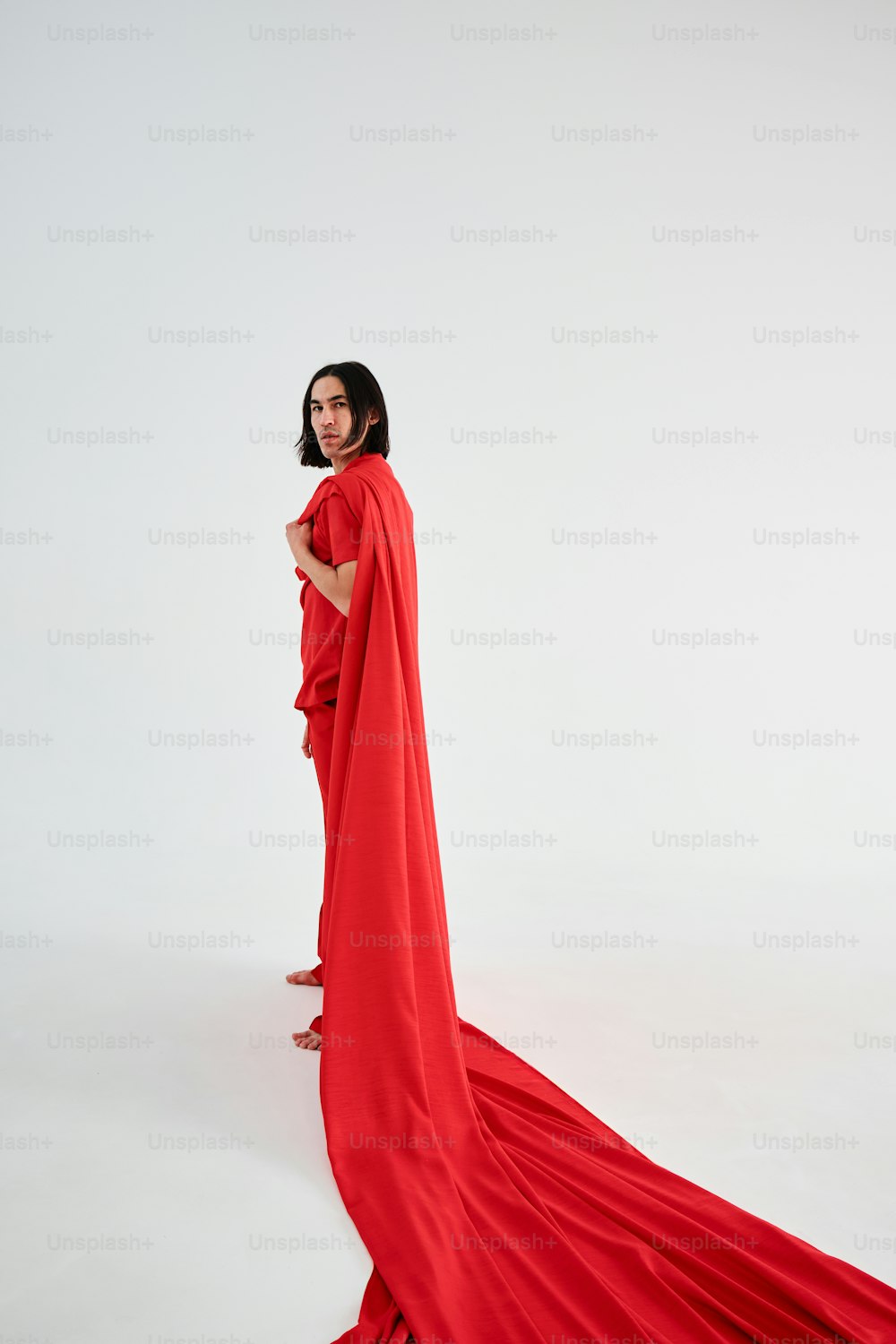 a woman in a red dress is standing