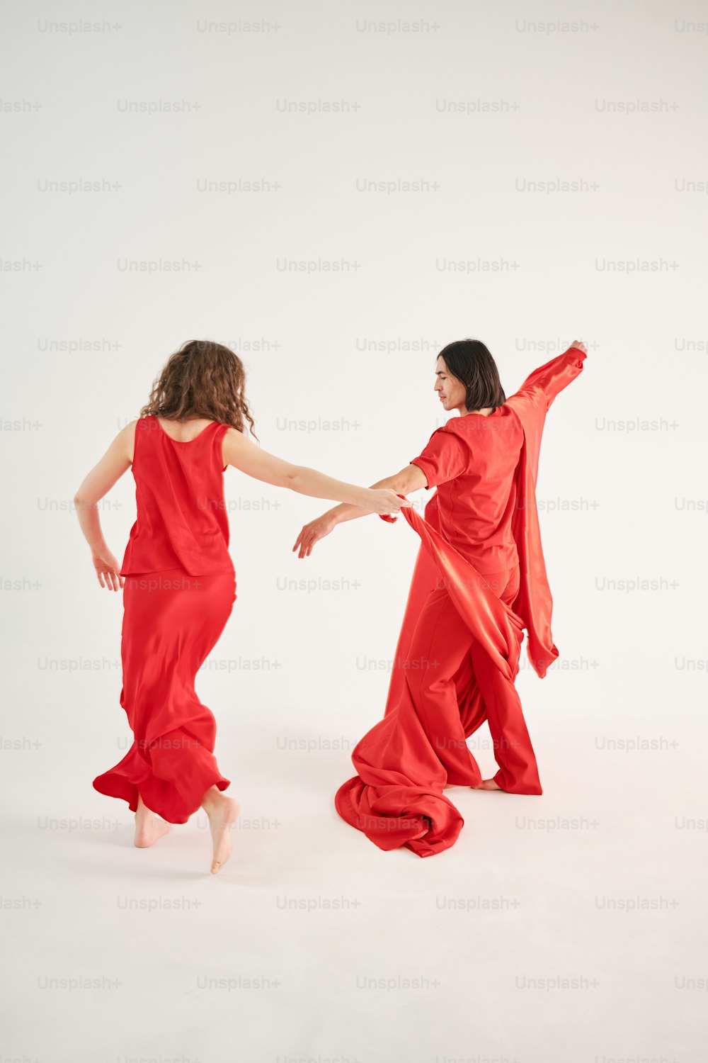 two women dressed in red dancing together