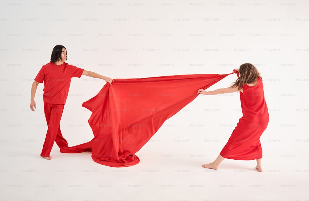 a woman in a red dress holding a red cloth