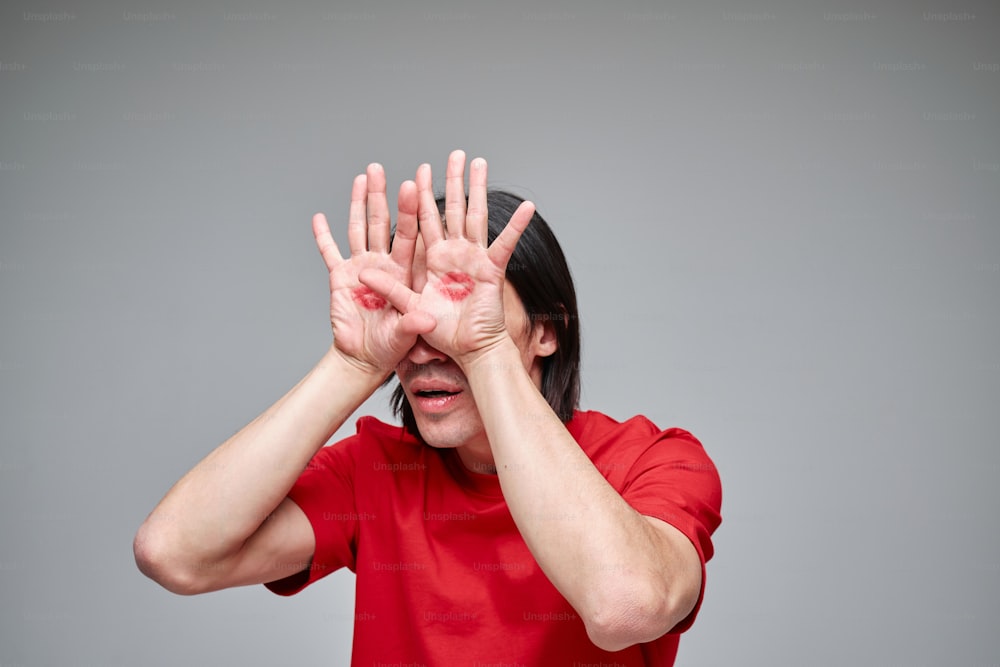 a woman covering her eyes with her hands