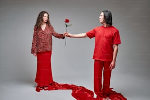 a man and a woman are holding a rose
