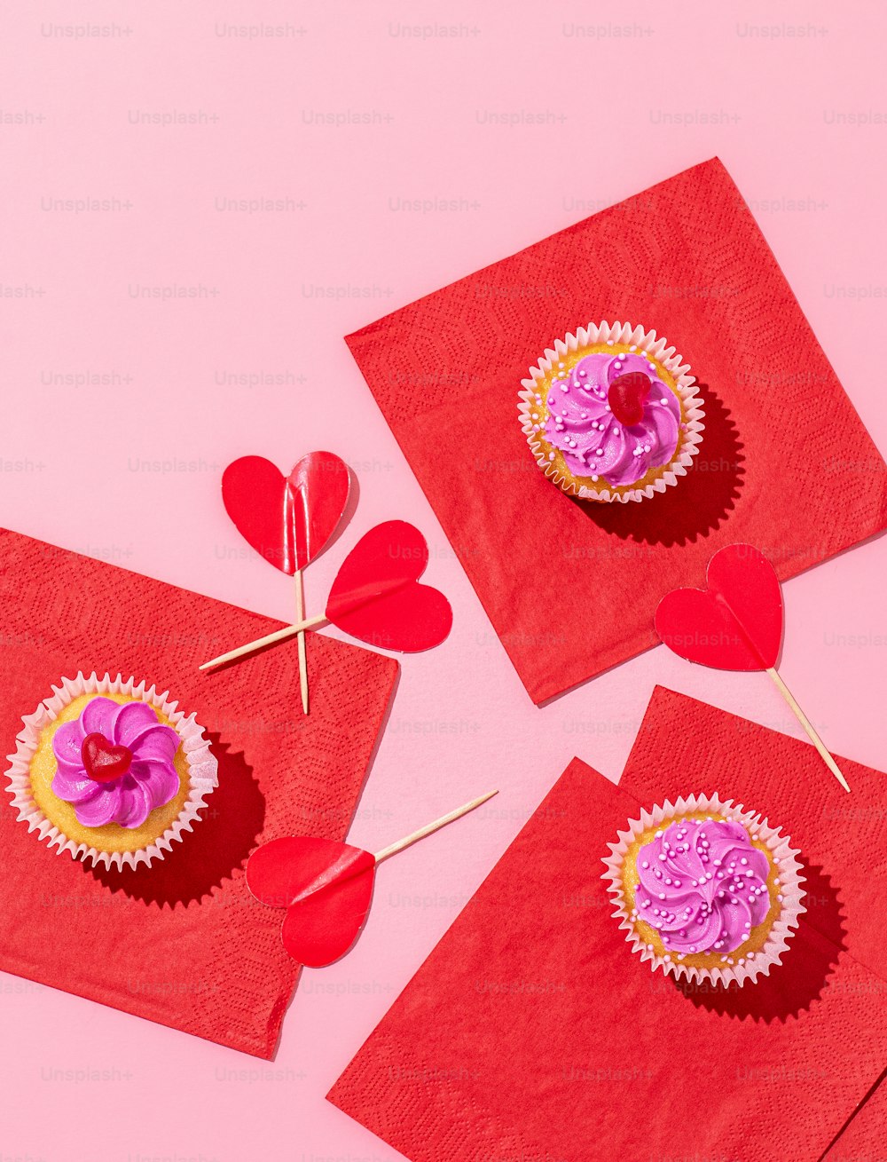 three red napkins with cupcakes on them