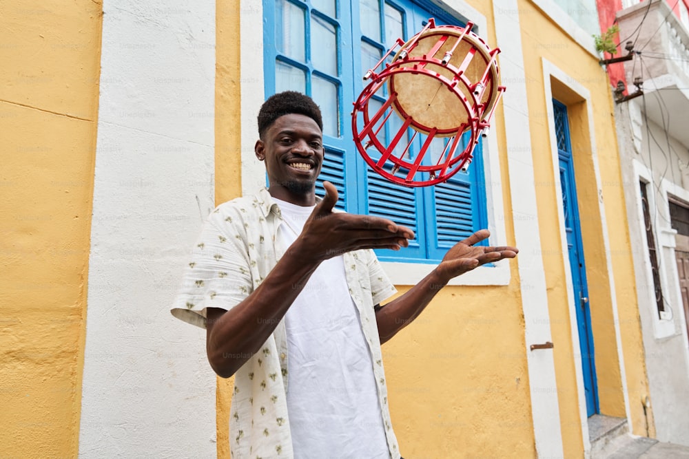 a man standing in front of a building holding a frisbee