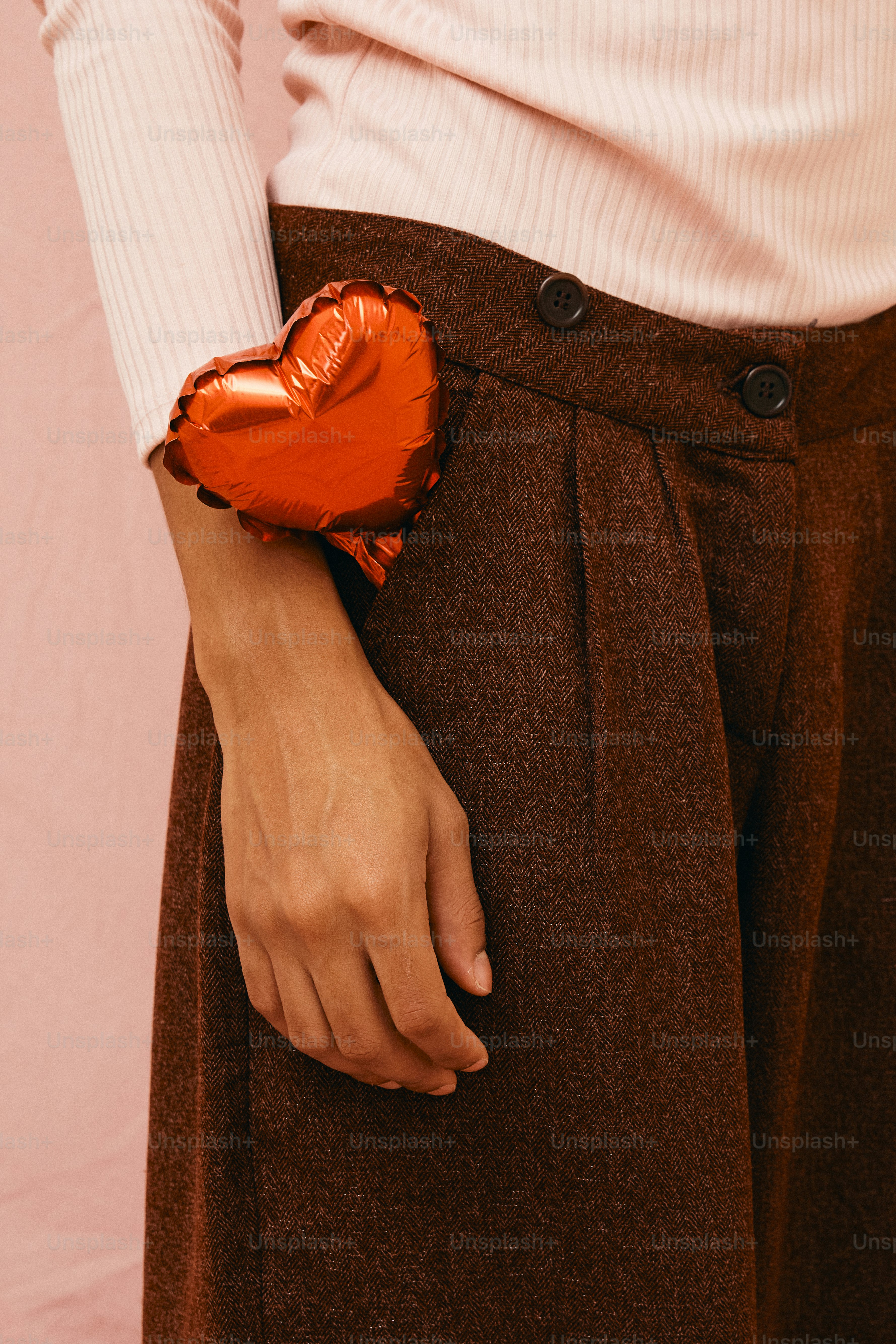 a close up of a person holding a heart shaped object