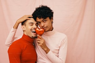 a couple of people that are holding a heart