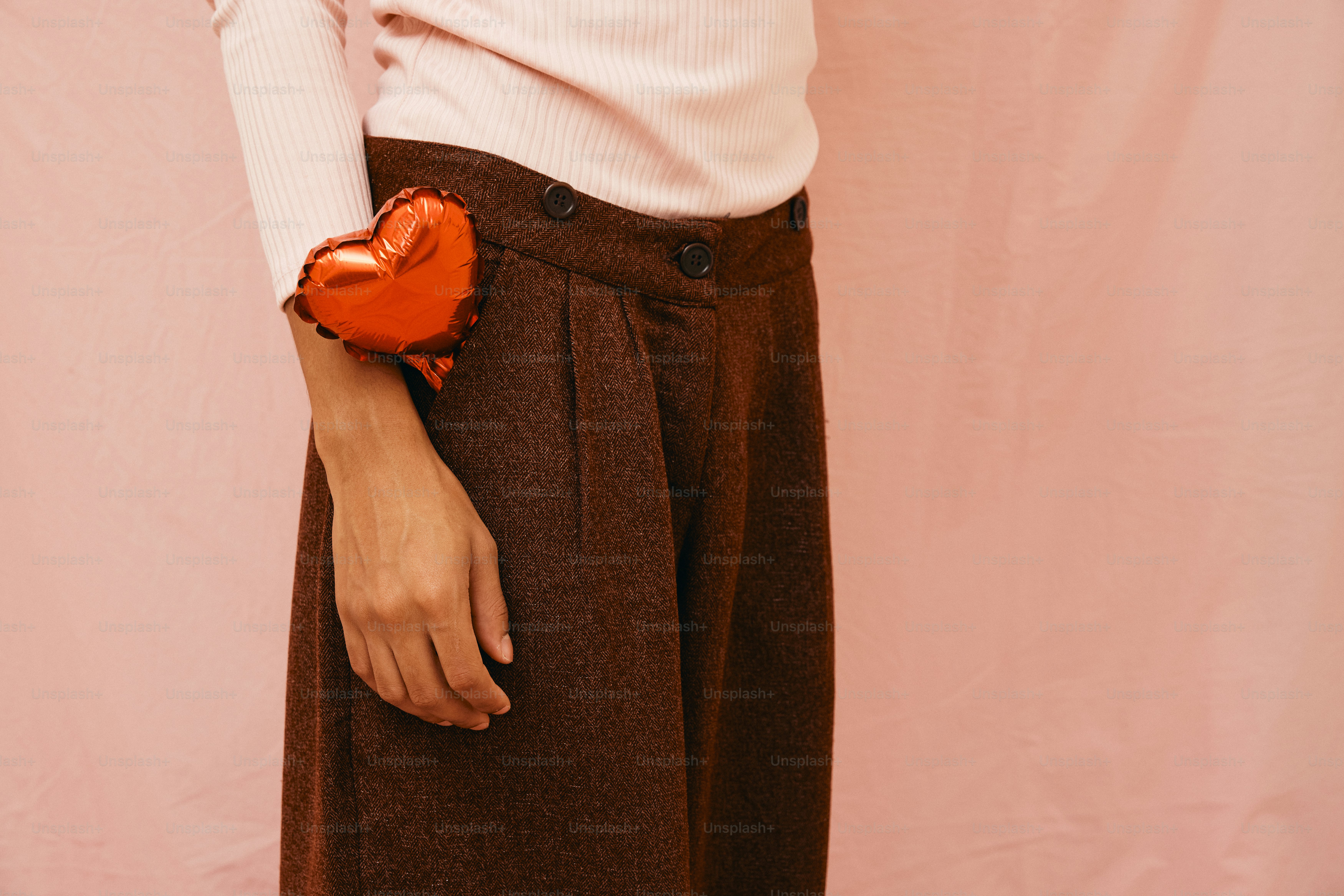 a woman holding a heart shaped object in her hand