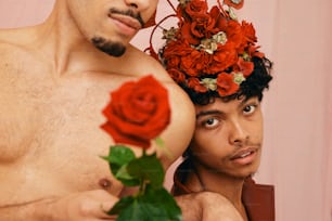 a man with a flower crown on his head next to a man with a rose