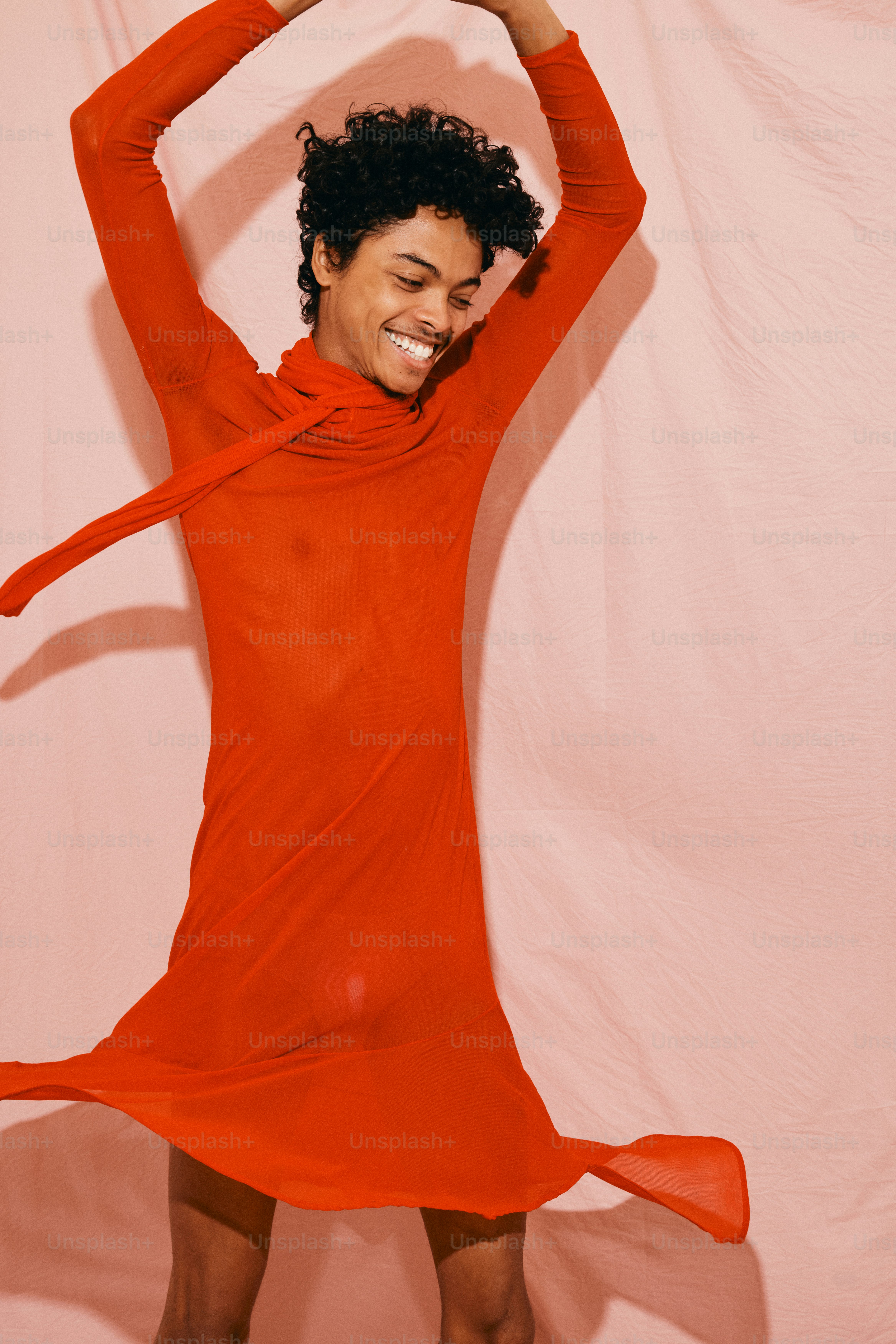 a woman in a red dress posing for a picture