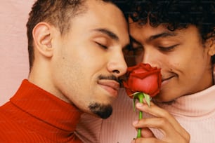 a man kissing a woman with a rose in his mouth