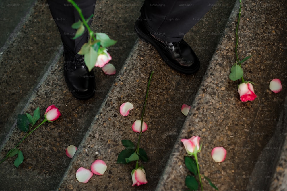 a close up of a person's feet with flowers on the steps