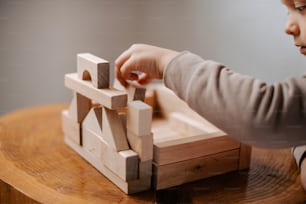 a young child playing with a wooden toy