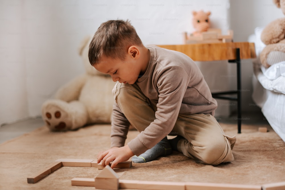 a little boy playing with a wooden toy