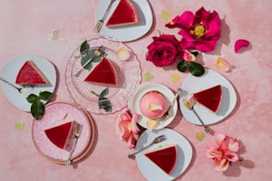 a table topped with slices of cake and flowers