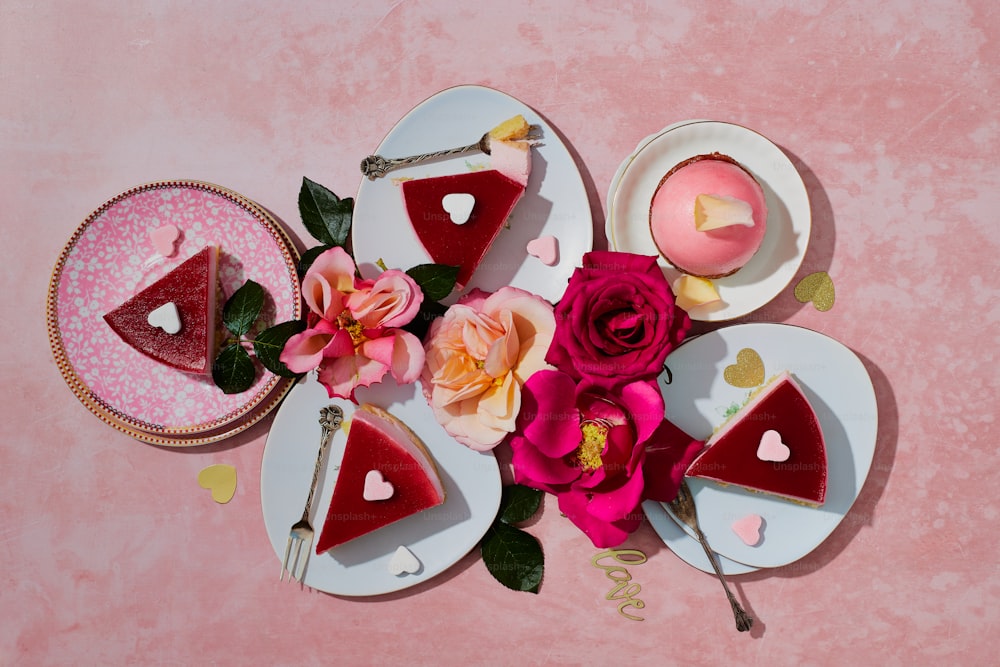 a table topped with plates of cake and flowers