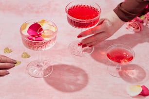 a table topped with wine glasses filled with liquid