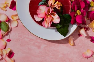 a white plate topped with pink and yellow flowers