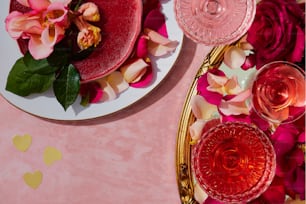 a table topped with plates and glasses filled with flowers