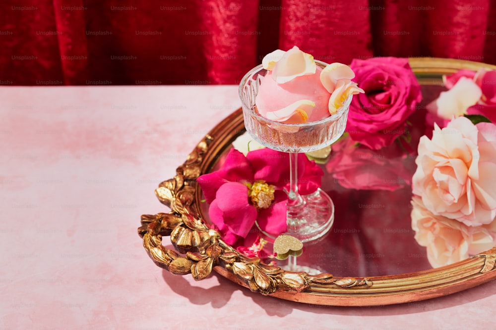 a table with a mirror and flowers on it