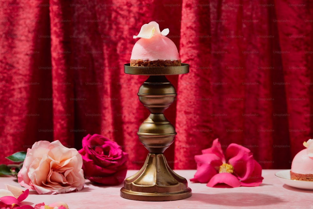 a table topped with a cake covered in frosting